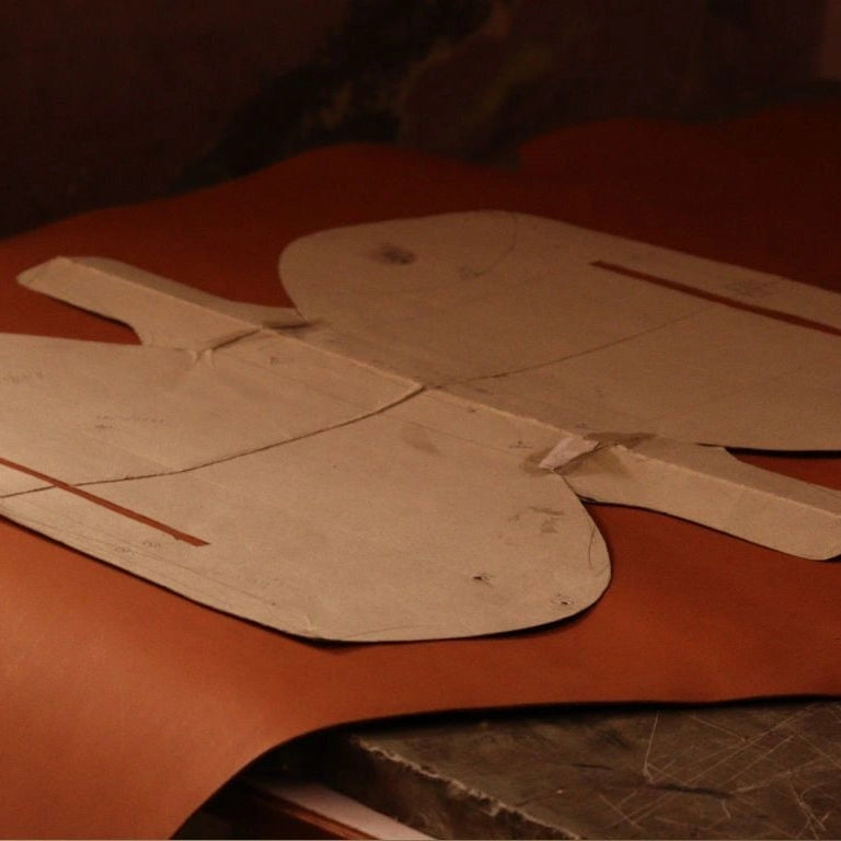 White design pattern on top of a tan leather hide