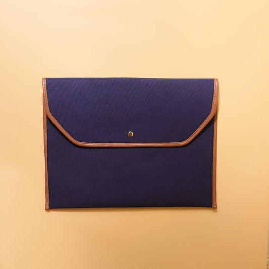 Document holder and laptop sleeve in Canvas with leather trims-Deep Blue Canvas with tan leather trim-gold plated metal snap button-beige felt lining-front view-The Bicyclist
