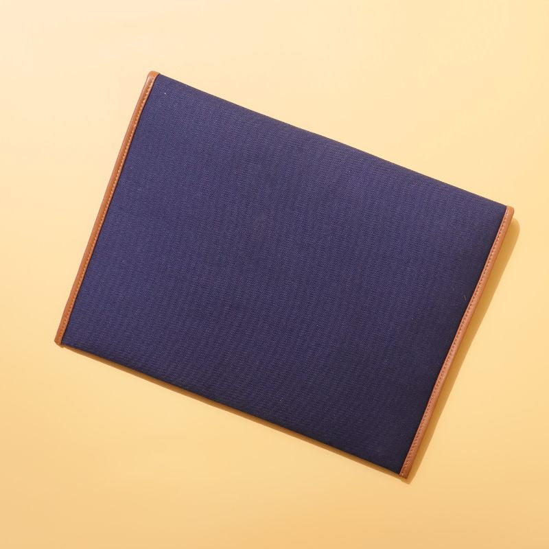 Document holder and laptop sleeve in Canvas with leather trims-Deep Blue Canvas with tan leather trim-gold plated metal snap button-beige felt lining-rear view-The Bicyclist
