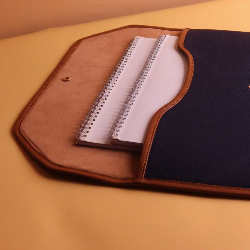 Document holder and laptop sleeve in Canvas with leather trims-Deep Blue Canvas with tan leather trim-gold plated metal snap button-beige felt lining-side open view-The Bicyclist