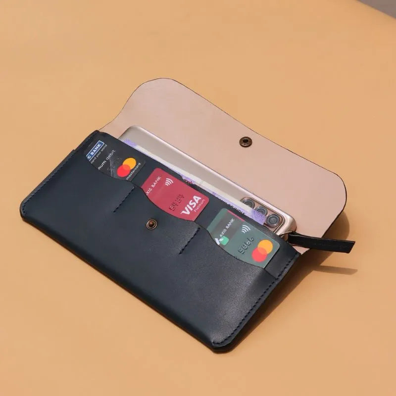 Handmade Leather Long Wallet for Women in Deep Blue on a peach background with the flap open and three card pockets with a snap button at the center and a light peach sheep leather lining