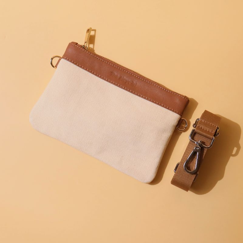 Canvas and Leather Compact Pouch Sling Bag-Off White Canvas and tan leather-gold plated metal hook-top front angle-The Bicyclist