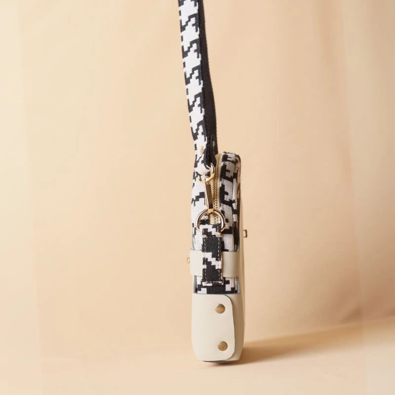 Side View of Canvas Sling bag with black and white houndstooth weave