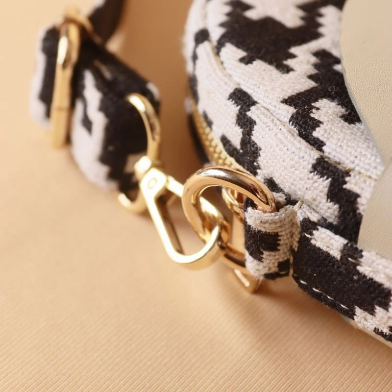 Detail Image of gold metal fittings from Canvas Sling bag with black and white houndstooth weave