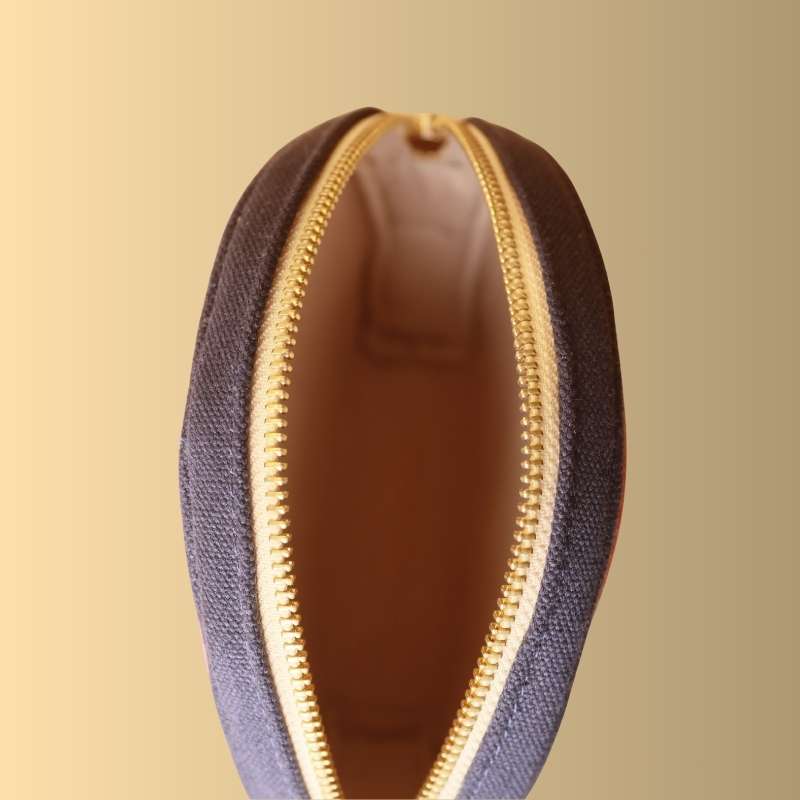 Top Open Internal view of a Deep Blue Canvas Crossbody sling bag with gold metal zip and light peach felt lining