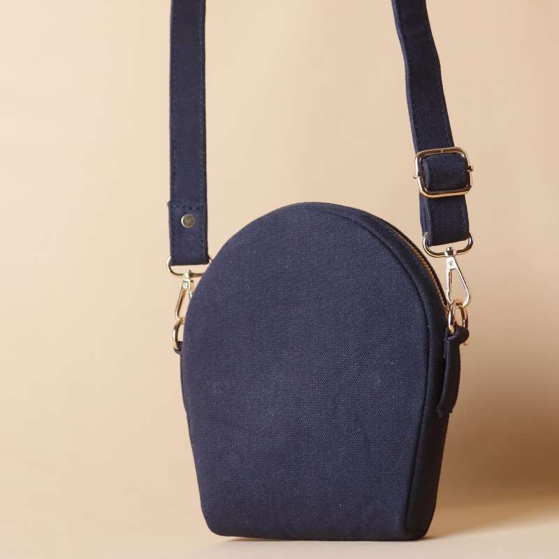 Front view of a Deep Blue Canvas Crossbody sling bag with its canvas strap extended