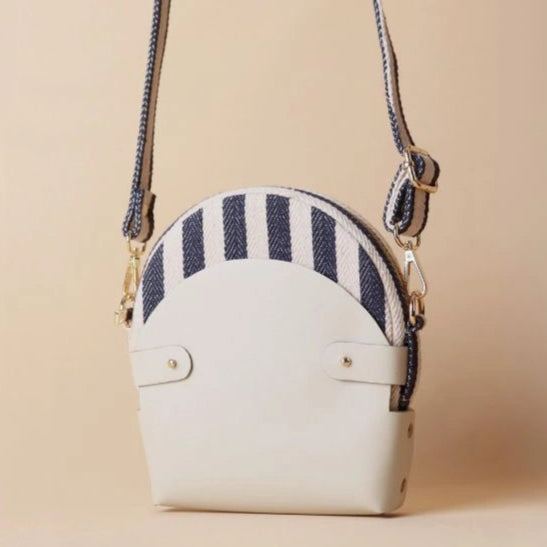 Front View of a Blue and White Stripe canvas crossbody sling bag in a off white leather case