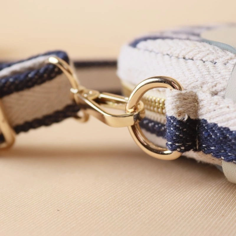 Detailed View of the gold metal fittings for a stirpe canvas crossbody sling bag