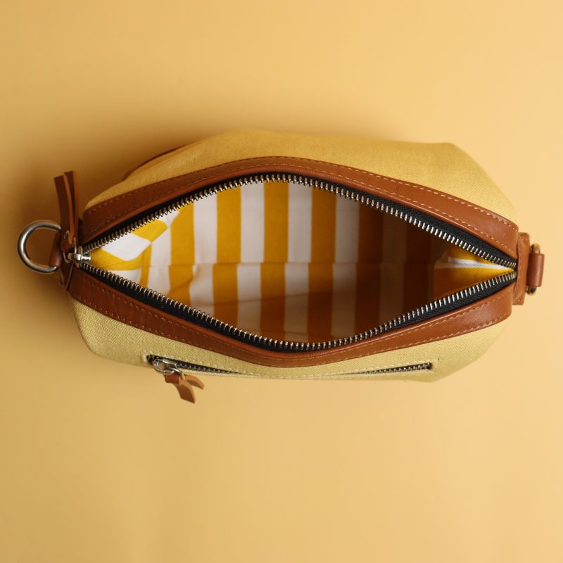 Yellow Canvas and Tan Sheep Leather Cosmetics Pouch Dopp Kit for women with Removable and Adjustable Sling straps a metal zip closure with a zipped pocket on the outside and chrome plated fittings top open view