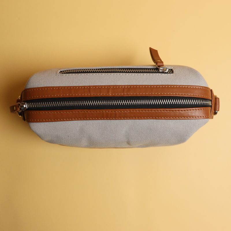 Grey Canvas and Tan Sheep Leather Shaving Pouch Dopp Kit with Removable and Adjustable Sling straps a metal zip closure with a zipped pocket on the outside and chrome plated fittings top closed view