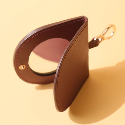 Vanity Mirror in a Deep Red Leather Casing with a Gold finished Metal Hook and a Gold Snap Button Open Side View