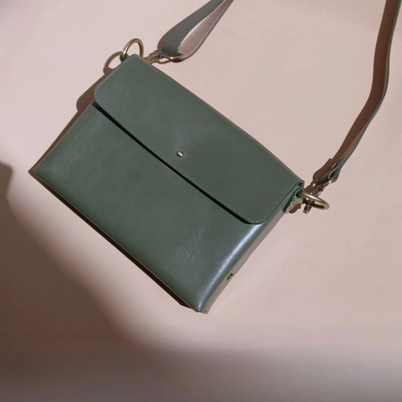 Top Flat View of a Green Leather Crossbody Sling bag with a flap