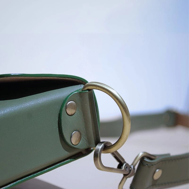 Detailed Fitting View of a Green Leather Crossbody Sling bag with light gold sling bag fittings