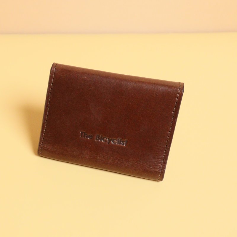 Dark Brown Bifold Leather Wallet with a Flap  Closure with a metal Snap Button in Gold Metal Finish and Three Card pockets with two cards in each pocket and one cash pocket  with a tan sheep leather lining back view