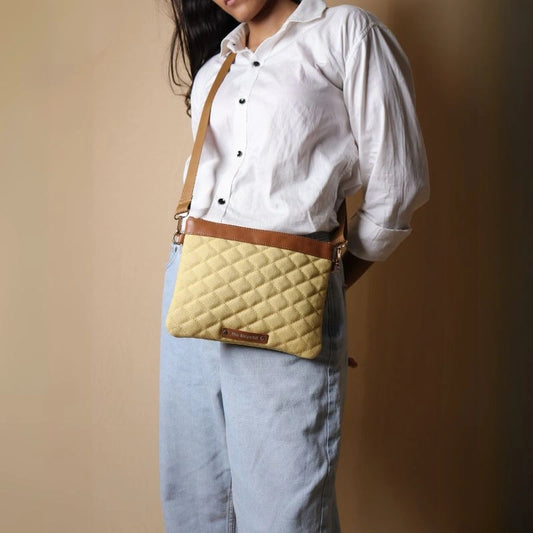 Woman in a White shirt carrying a quilted yellow cotton canvas crossbody sling pouch bag across her shoulder