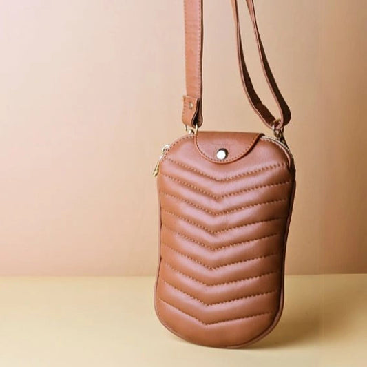 A Tan Leather Quilted Shoulder Crossbody sling pouch bag with its straps extended