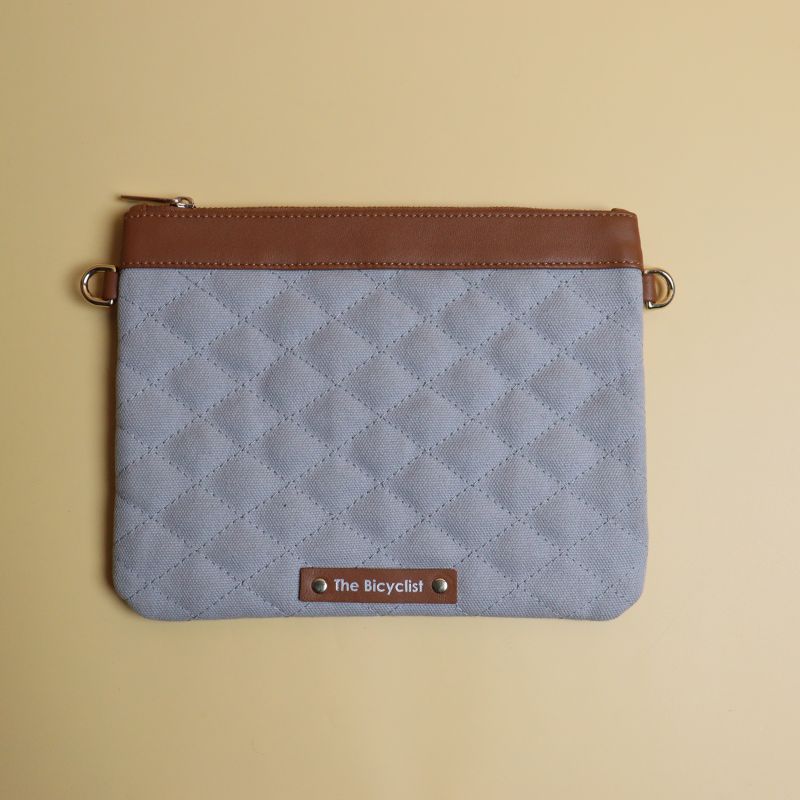 Small Crossbody Sling Pouch for Women with a Quilted gray Canvas and Tan Sheep Leather Trimming with a Zip Closure removable and adjustable straps in chrome plated finish front view