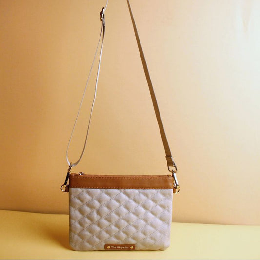 Small Crossbody Sling Pouch for Women with a Quilted gray Canvas and Tan Sheep Leather Trimming  with a Zip Closure  removable and adjustable straps in chrome plated finish standing view