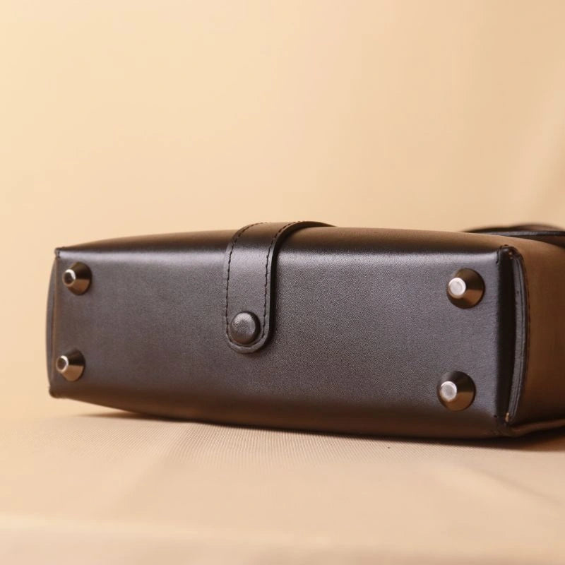 Bottom view of Black Leather Crossbody Sling Bag with Metal Base Studs and Leather covered button