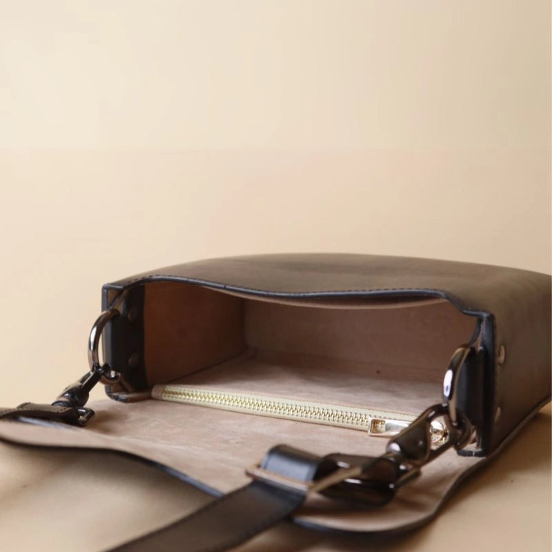 Open View of Black Leather Crossbody Sling Bag with light beige felt lining, metal zip pocket and open pocket