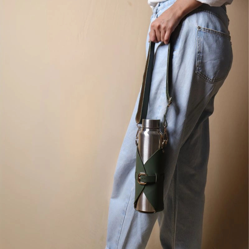 Woman Carrying a Leather Bottle Carrier with a Stainless Steel Bottle