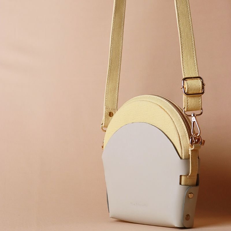 Hancrafted Canvas and Leather slingbag-yellow canvas body with off-white leather case cotton lining-adjustable and removable shoulder straps-gold plated metal fittings-leather case handbag leather case and canvas bag reverse view-The Bicyclist