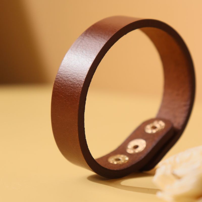 Minimal Leather Wristband bracelet-Dark Brown-adjustable with-gold plated metal snap button-front angle view-The Bicyclist