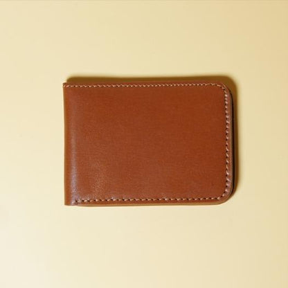 Tan Brown bifold leather wallet on a beige background