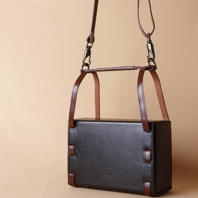 Rear View of a Structured Box Black Leather Shoulder Handbag with Dark Brown straps