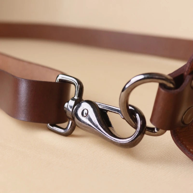 Detail view of the fittings used in a Structured Box Black Leather Shoulder Handbag with Dark Brown straps