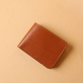 Tan Brown leather wallet on a beige background