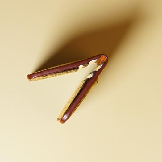 Closeup of the edge of a leather card wallet in Maroon