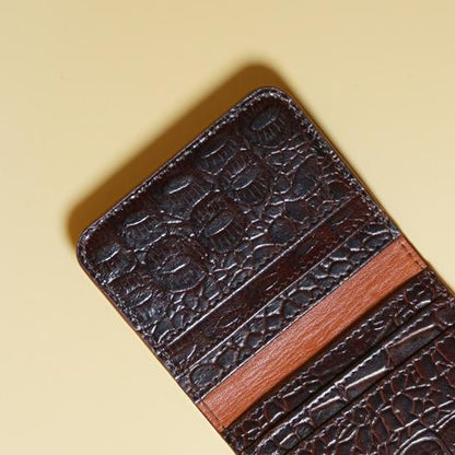 Maroon color crocodile textured cardwallet with tan leather lining on a beige background