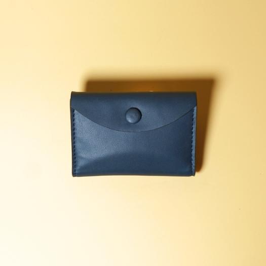 Blue leather wallet on a yellow background