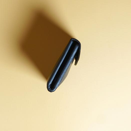 Close up side view of a blue leather wallet