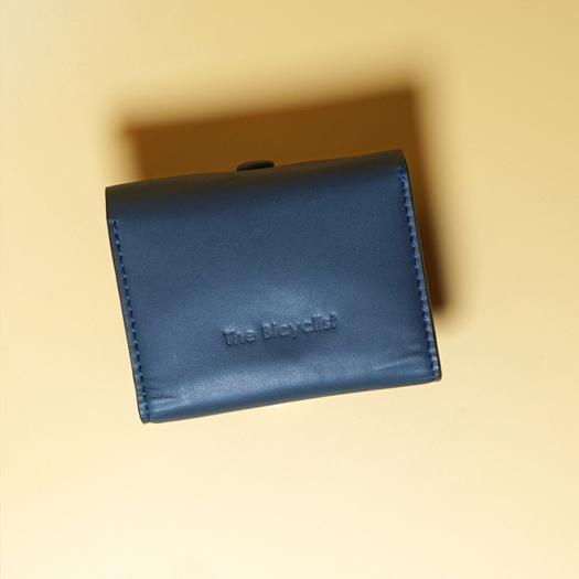 Blue Leather wallet with a brand, The Bicyclist embossed on it