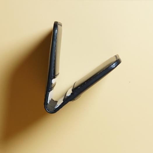 Closeup view of the edge of a black leather card wallet