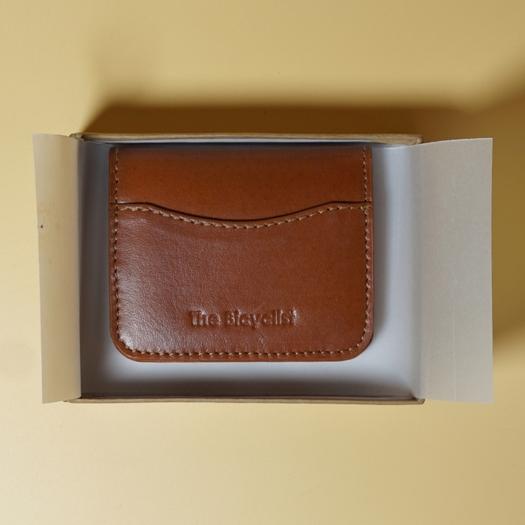 Tan Brown leather cardholder in a box on a beige background
