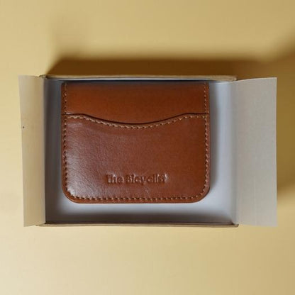Tan Brown leather cardholder in a box on a beige background