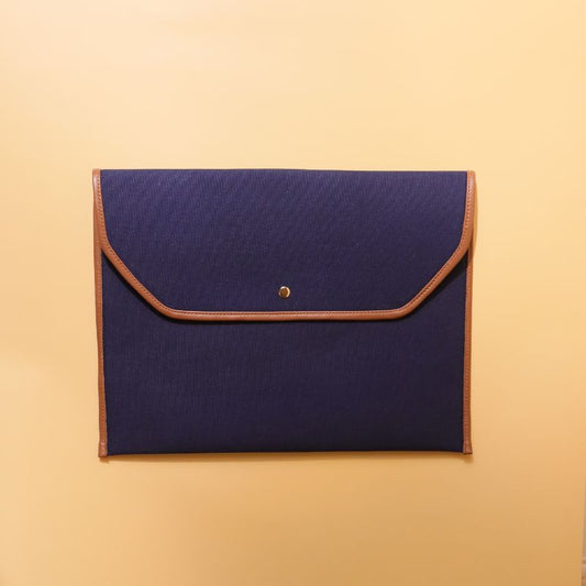 Document holder and laptop sleeve in Canvas with leather trims-Deep Blue Canvas with tan leather trim-gold plated metal snap button-beige felt lining-front view-The Bicyclist 