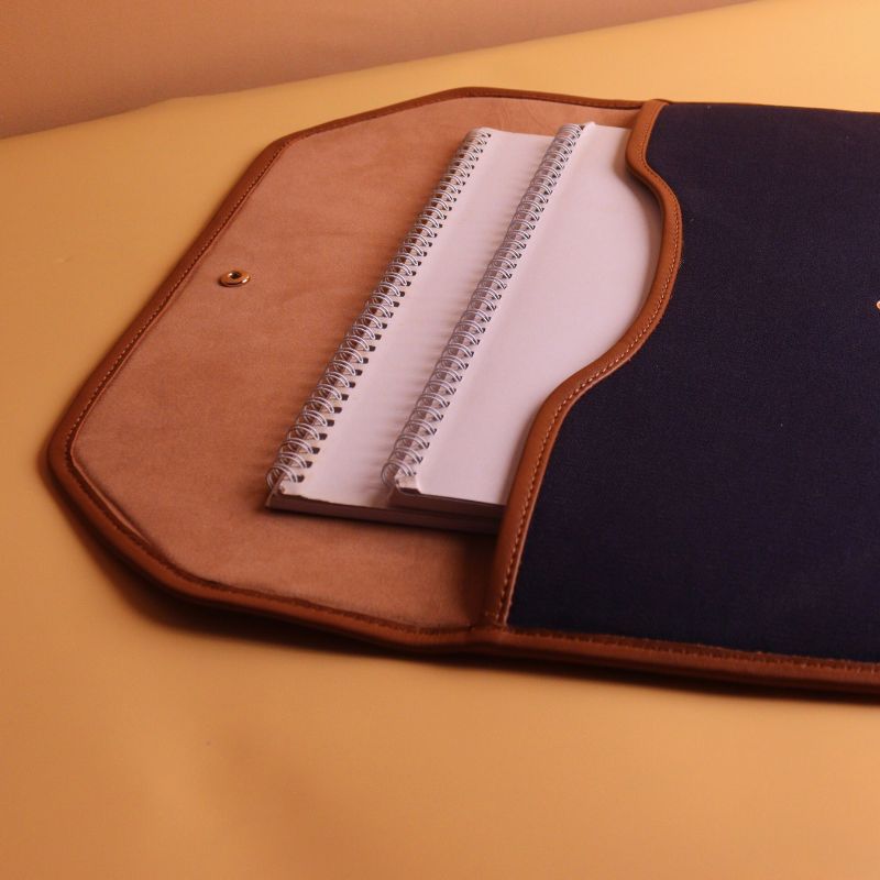 Document holder and laptop sleeve in Canvas with leather trims-Deep Blue Canvas with tan leather trim-gold plated metal snap button-beige felt lining-side open view-The Bicyclist 
