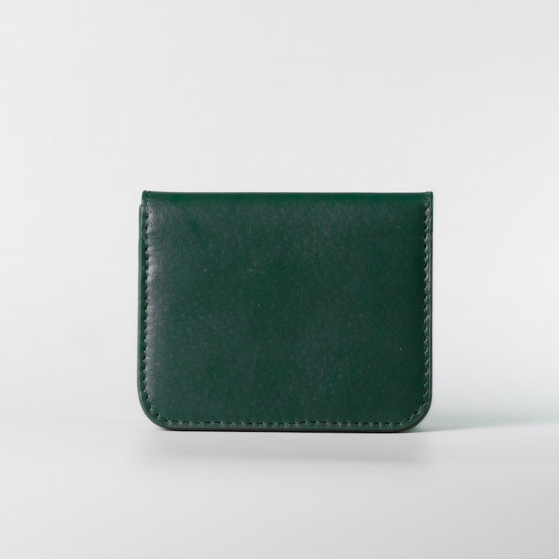 A dark green full grain leather bifold wallet with visible stitching along the edges, centered on a light gray background.