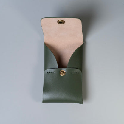 An olive green full grain leather card pouch with a light beige felt interior lining and brass snap closures made by, 'The Bicyclist' shown open against a neutral gray background.