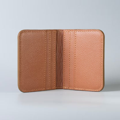 A tan pebbled leather wallet shown open, displaying its interior with 6 card card slots and stitching, set against a clean light gray background.