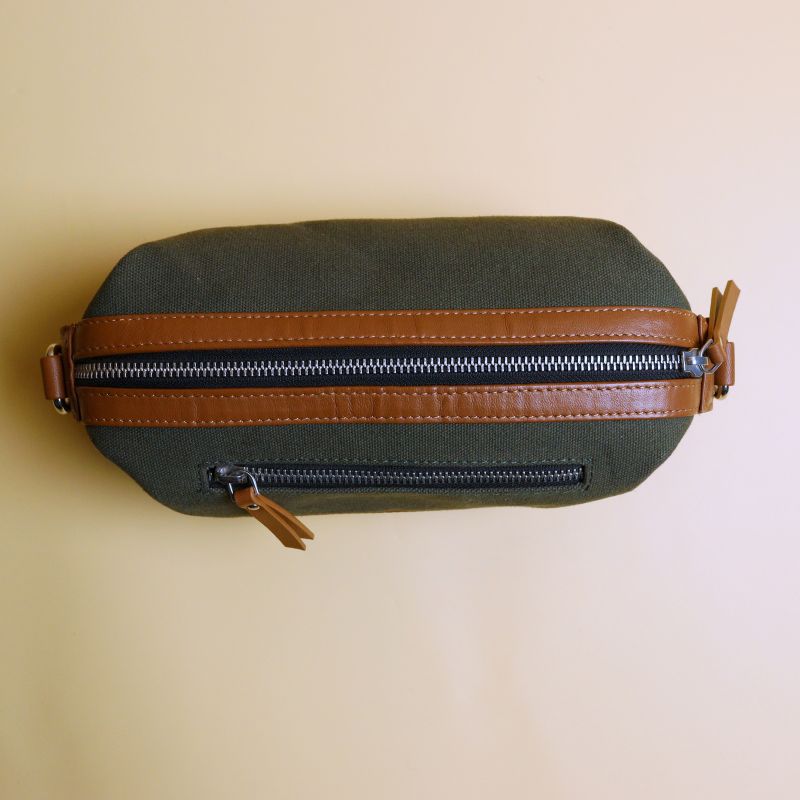 Canvas and Leather Dopp Kit Pouch Sling Bag-Dark Green Canvas body and tan leather trims-gold plated metal hook and zipper-top closed-The Bicyclist