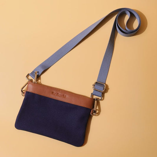 Canvas and Leather Compact Pouch Sling Bag-Deep Blue Canvas and tan leather-gold plated metal hook-front angle view-The Bicyclist