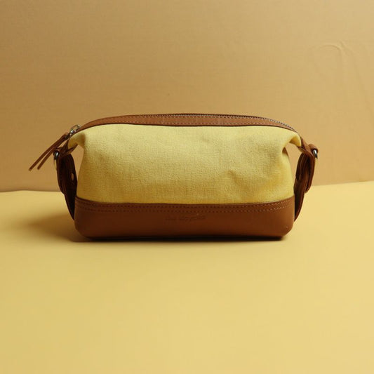 Yellow Canvas and Tan Sheep Leather Cosmetics Pouch Dopp Kit for women with Removable and Adjustable Sling straps a metal zip closure with a zipped pocket on the outside and chrome plated fittings front view