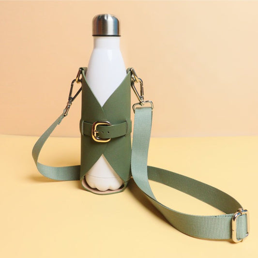 Leather one liter bottle carrier case in Dark Green with chrome plated finish metal fittings and a removable and adjustable nylon strap along with a white bottle front standing image