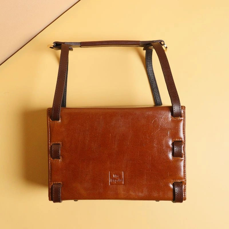 Back view of  Tan Leather structured box crossbody handbag with dark brown straps