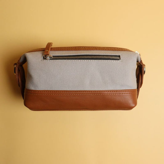 Grey Canvas and Tan Sheep Leather Shaving Pouch Dopp Kit with Removable and Adjustable Sling straps a metal zip closure with a zipped pocket on the outside and chrome plated fittings back view